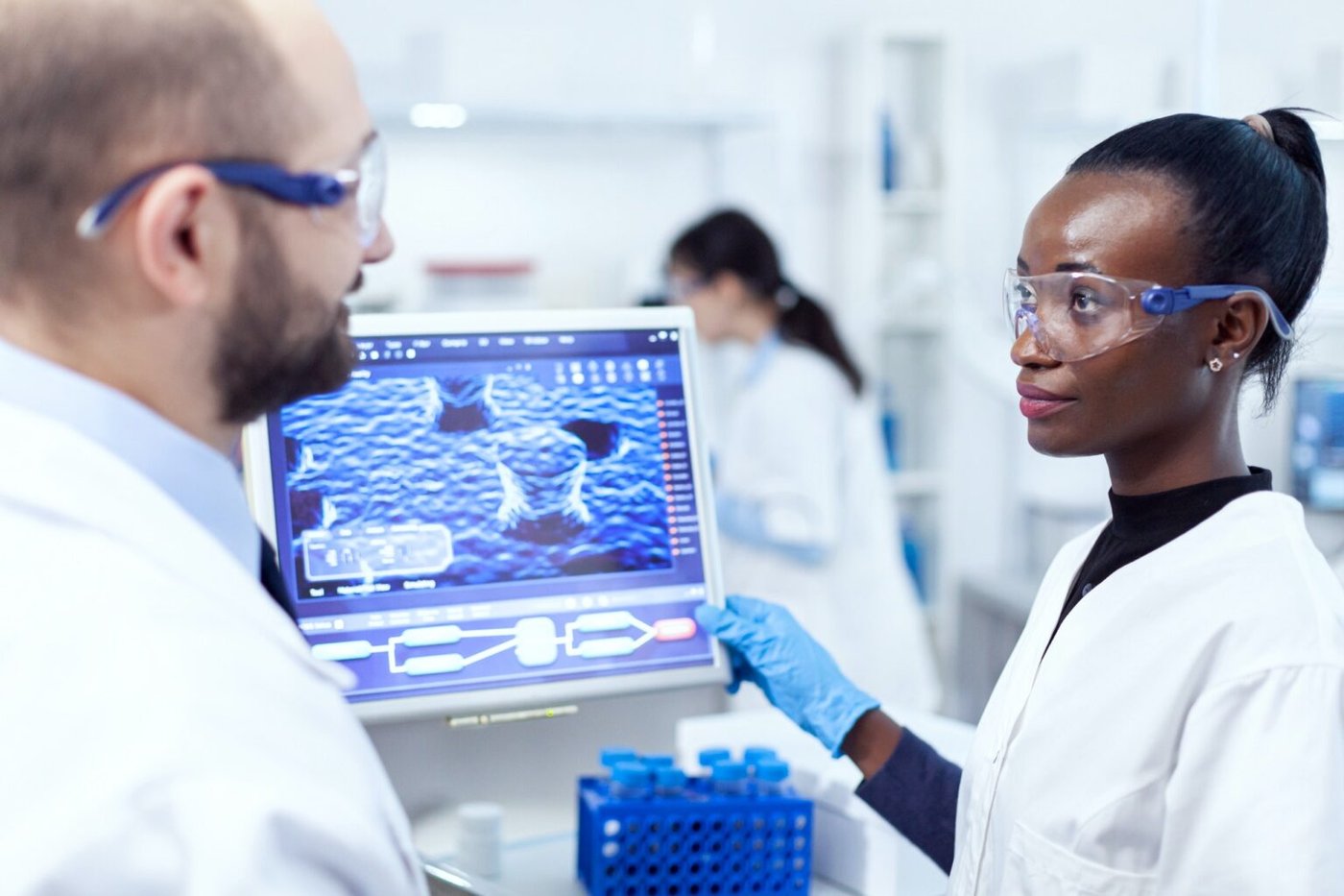 Research team discussing clinical study data in laboratory